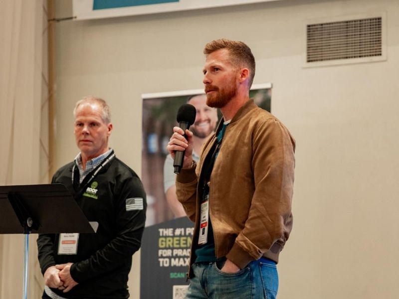 Joey Coberly and Kevin Salters speaking on stage